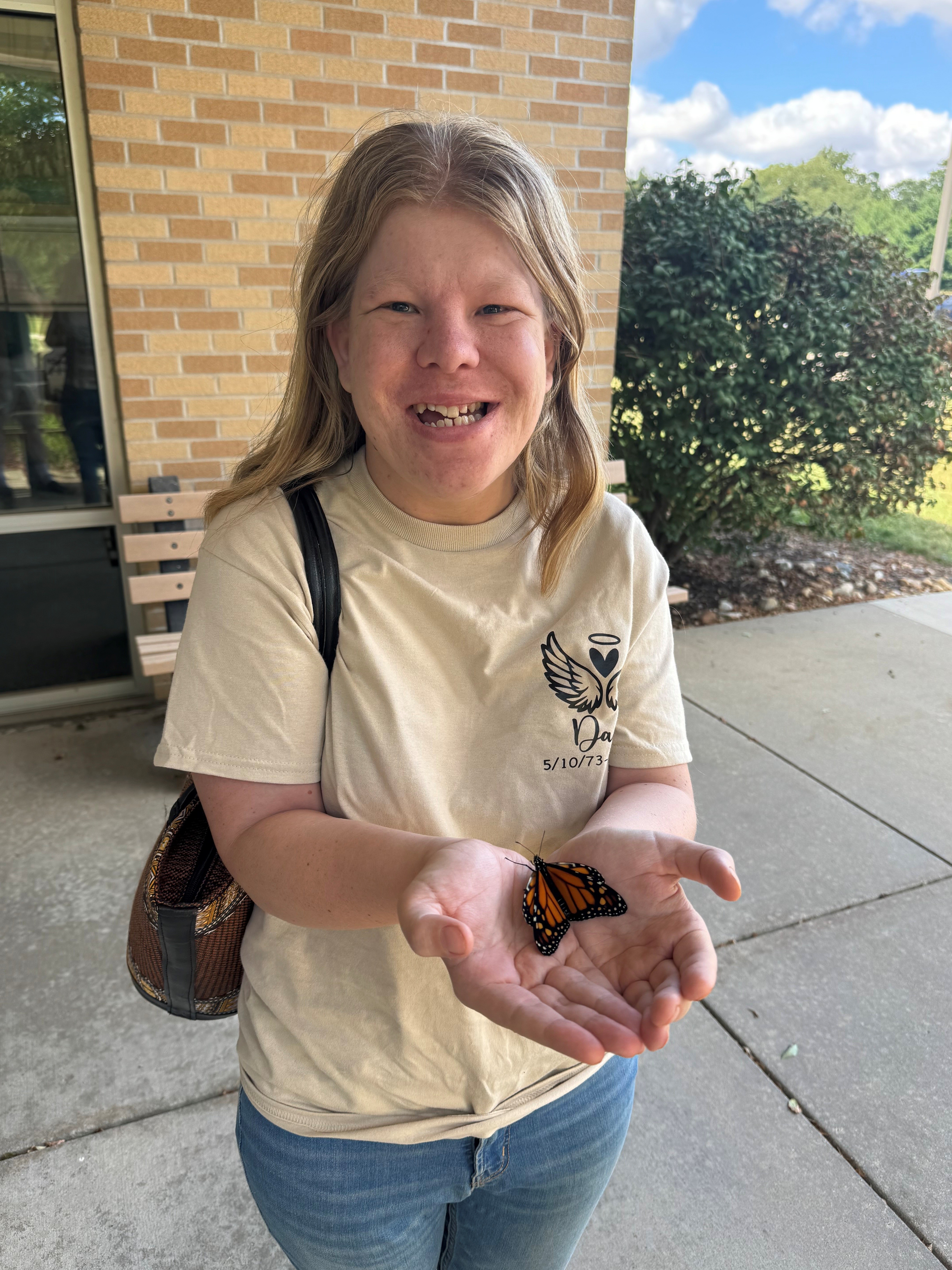 Butterfly in the palm of young woman