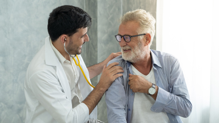 Doctor consulting with older man patient