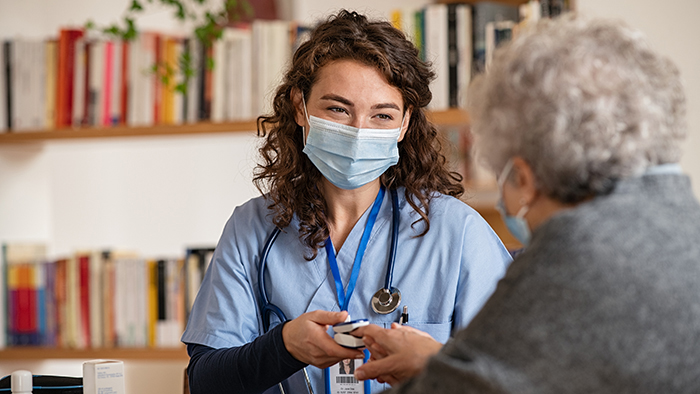 Young female nurse with senior female patient