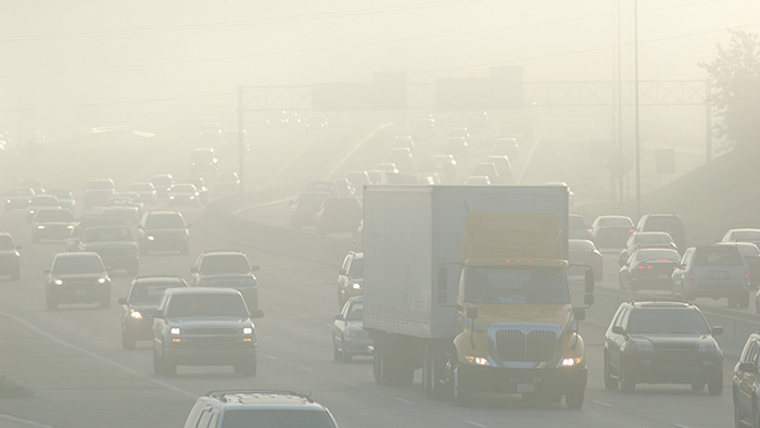 Traffic traveling through a smoke haze