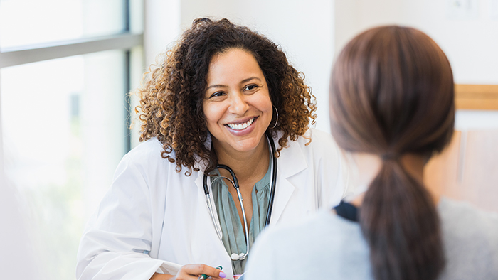 Female physician speaking with patient