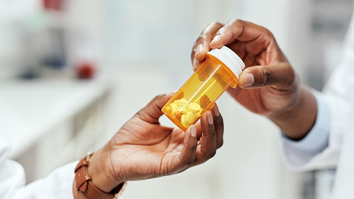 doctor handing patient prescription