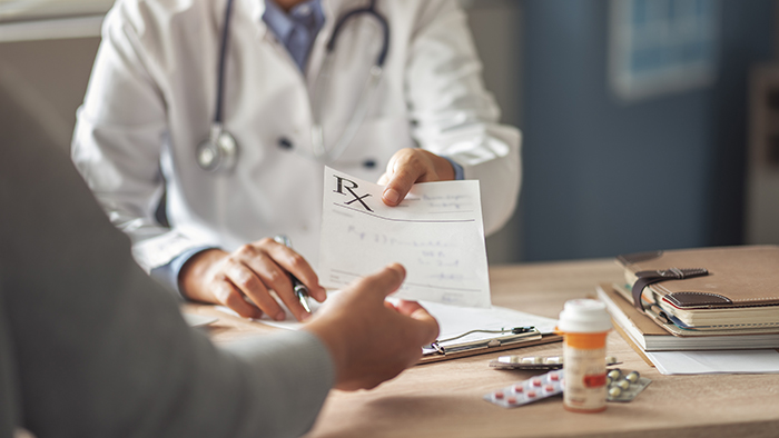 doctor handing presciption