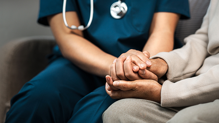 nurse holding patients hands