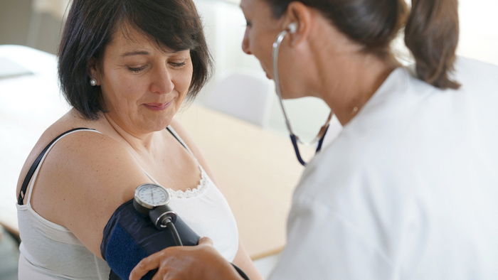 Woman having her blood pressure monitored