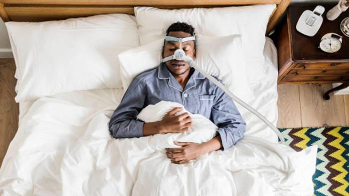 Man at home with CPAP machine