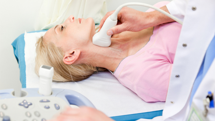 Woman receiving a ultrasound on her neck