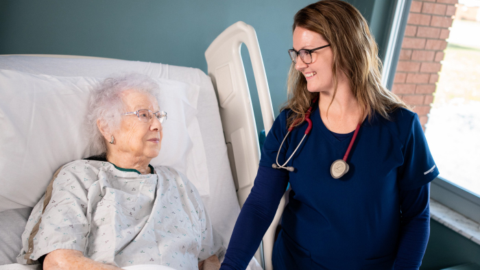 Young medical professional with elderly patient