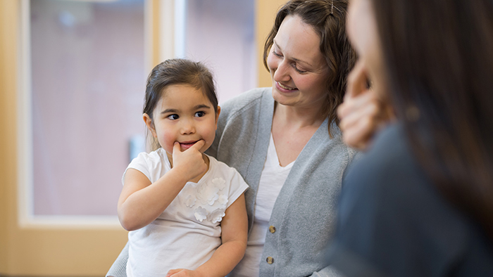 Little girl practicing speech with speech therapist