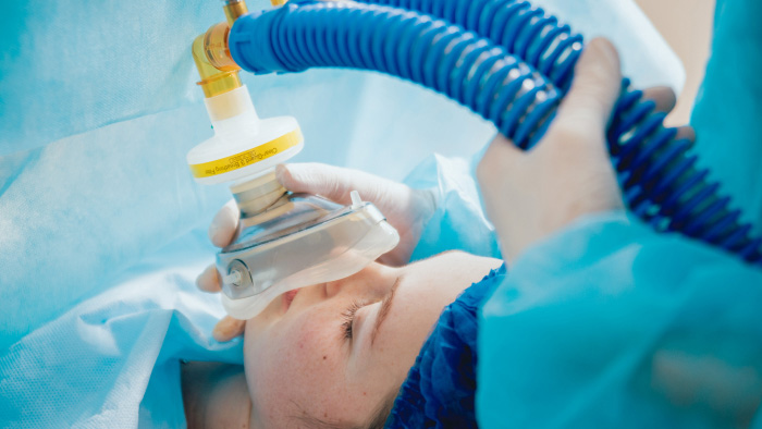 Woman receiving anesthesia during surgery