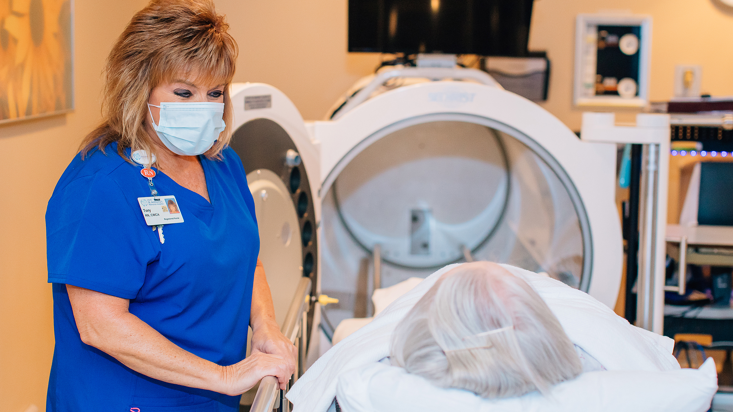 Young nurse explaining hyperbaric procedure to patient