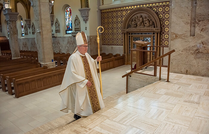 Bishop Rickens walking through chapel