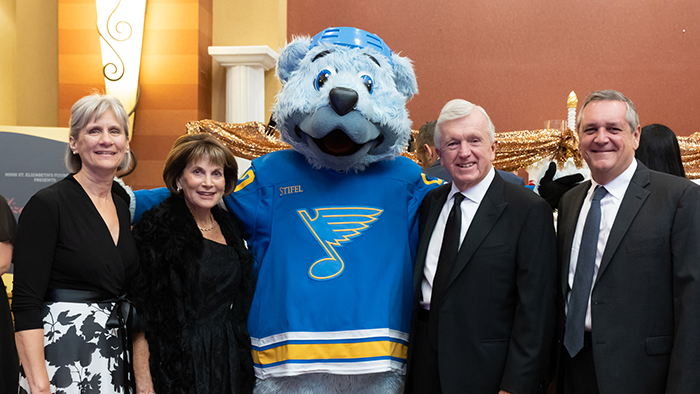 Elizabethan Gala attendees with St. Louis Blues mascot. 