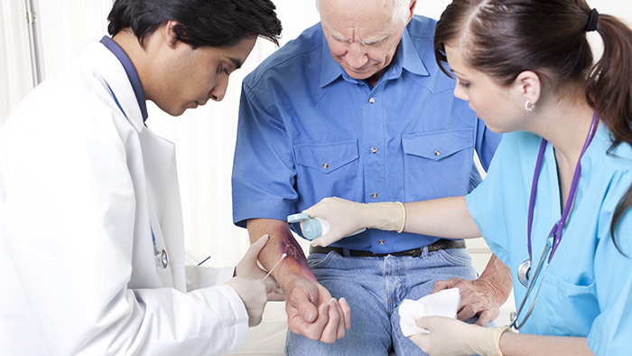 female nurse and doctor looking at wound