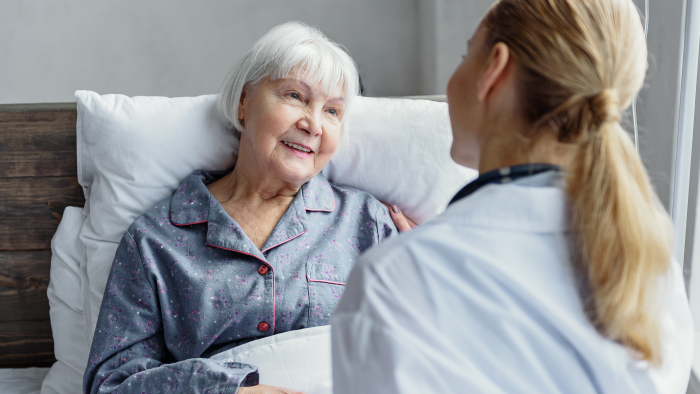 Woman nurse comforting a woman patient