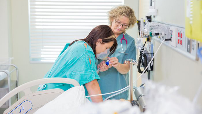 Young woman in labor with nurse