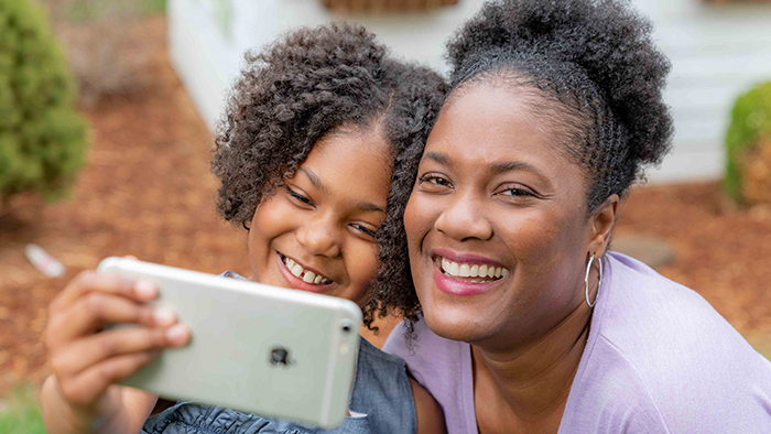 Black woman and daughter taking a selfie