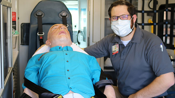 Mobile Simulation Lab with CPR mannequin and young male trainer 