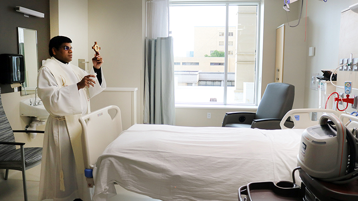 Father blessing the CVICU patient room