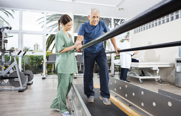 Female physical therapist assisting patient