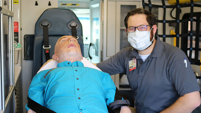 Mobile Simulation Lab with CPR mannequin and young male trainer 