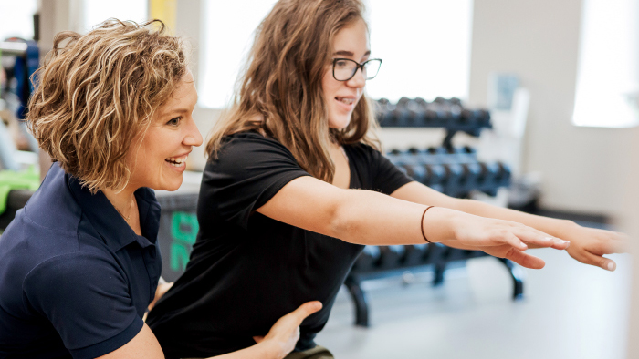 AthletiCare physician working with young girl athlete