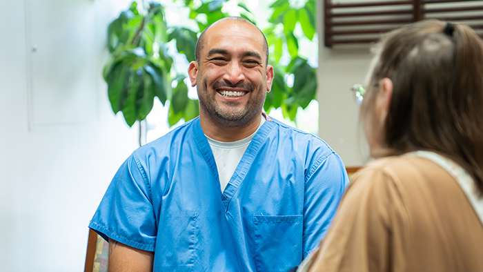 Male wound care nurse smiling at patient