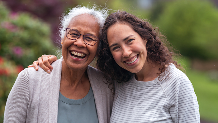 Mom and daughter smiling and embracing