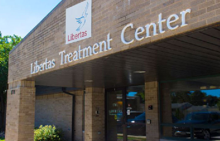 Exterior sign and entrance to Libertas Treatment Center in Green Bay