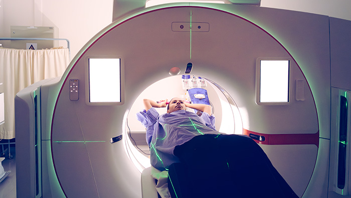 man inside of a PET scan machine