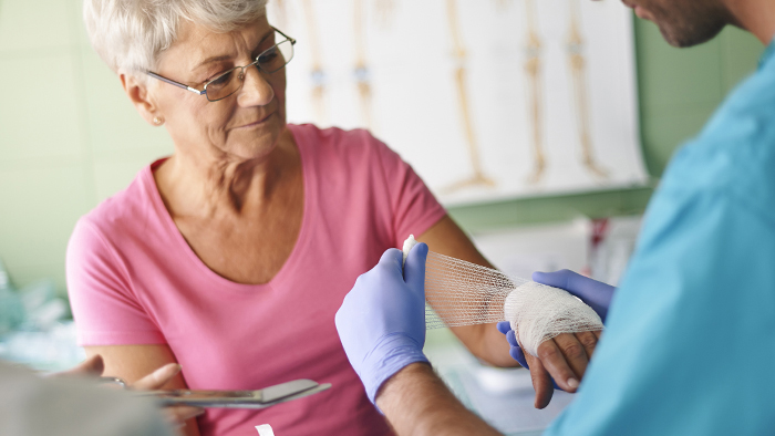 Woman receiving wound care treatment