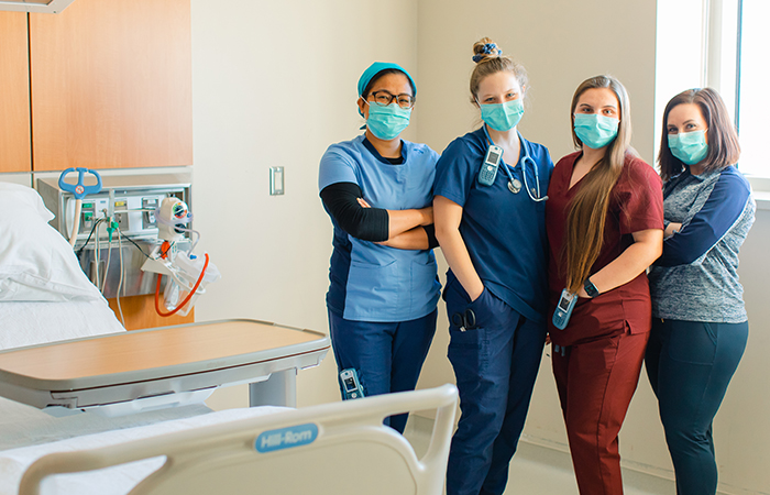 Female doctor listening to the heart of senior female patient