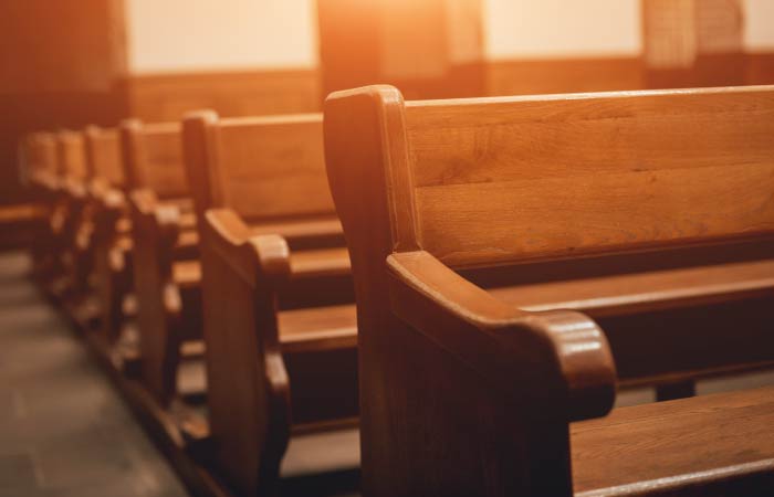 Chapel pews in golden sunlight