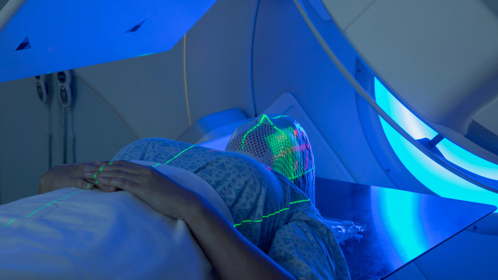 Woman positioned on CT Scan table for treatment