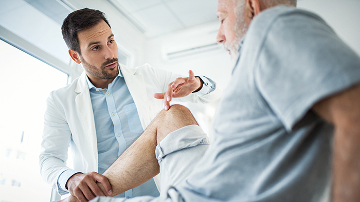 Doctor consulting with older man patient