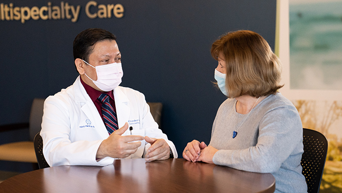A provider speaks with patient about colonoscopies