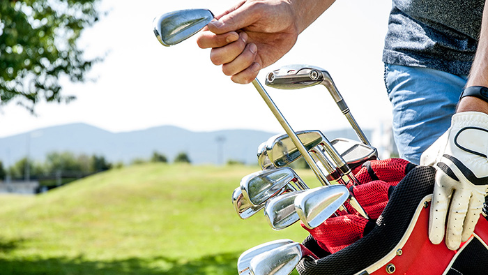 Man reaching for golf club