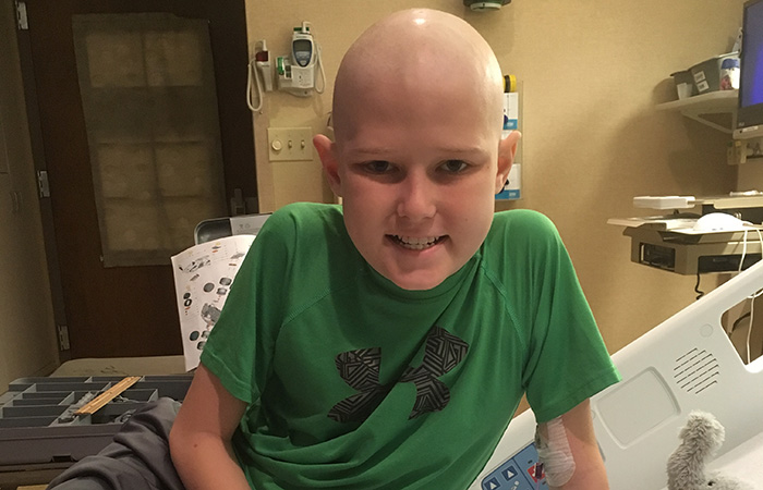 Forrest sitting in a hospital bed at HSHS St. Vincent Children's Hospital in Green Bay.