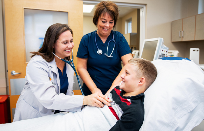 Sacred Heart_Urgent Care homepage_smiling doctor and nurse with boy