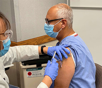 Dr. Ashok Rai receiving COVID-19 vaccine