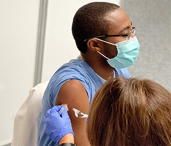 Dr. Richard Amankwah receiving COVID-19 vaccine