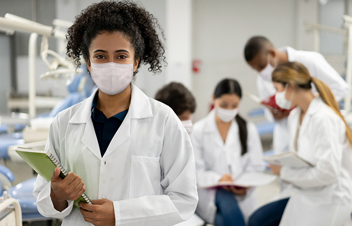 Black doctor with nurses in background