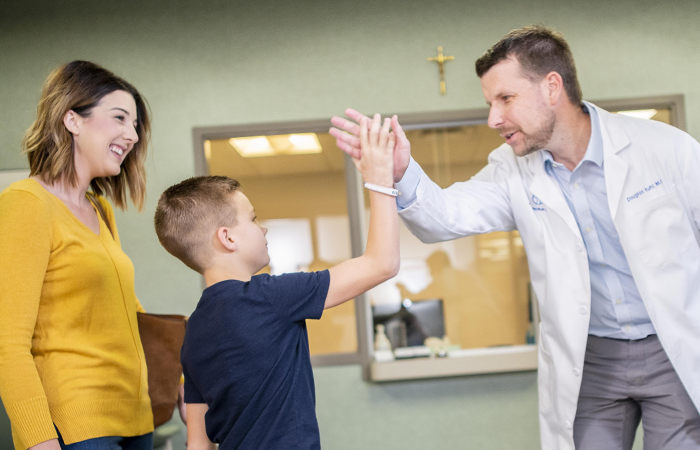 St Johns About Us 2018 Annual Report Doctor High Fiving Patient