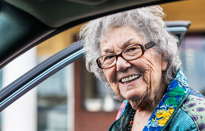 Elderly woman getting into care