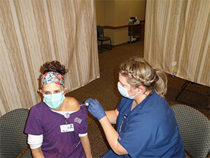Vicki Zimmerman receiving COVID-19 vaccine