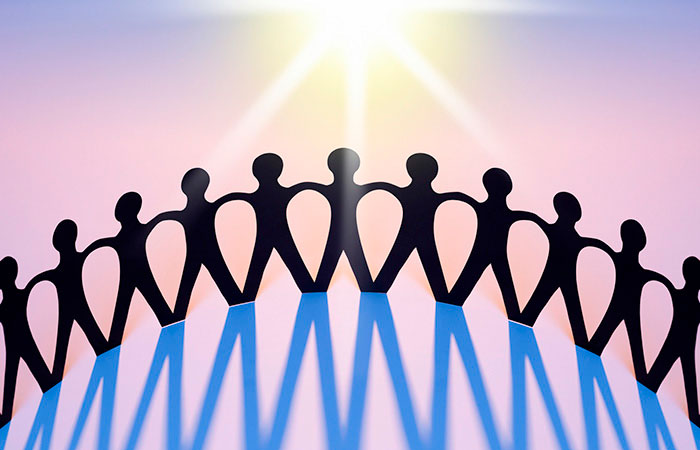 Community of people holding hands