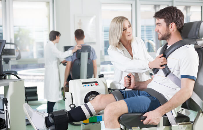 Young adult male patient recieving care from a middle aged orthopedist