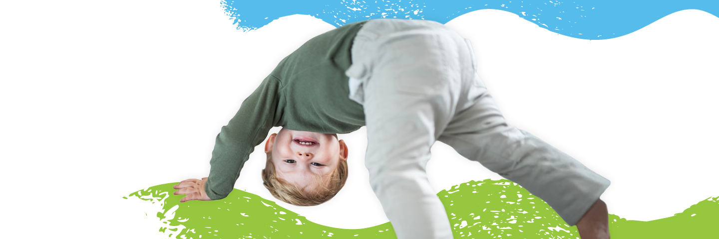 child dancing in front of a background painted with swirls