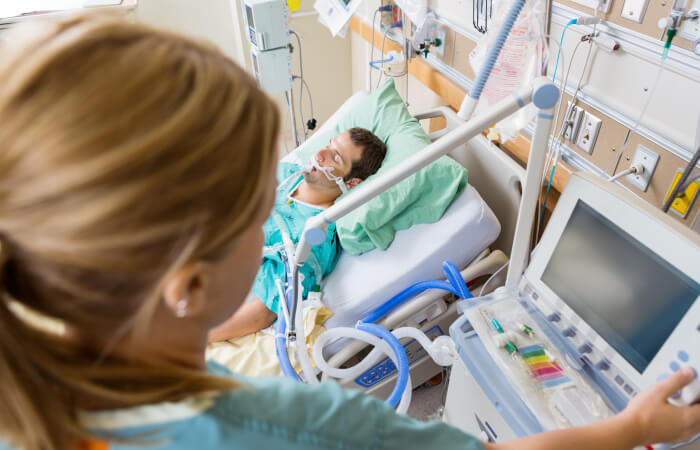 Nurse checking monitors near Intensive Care patient 