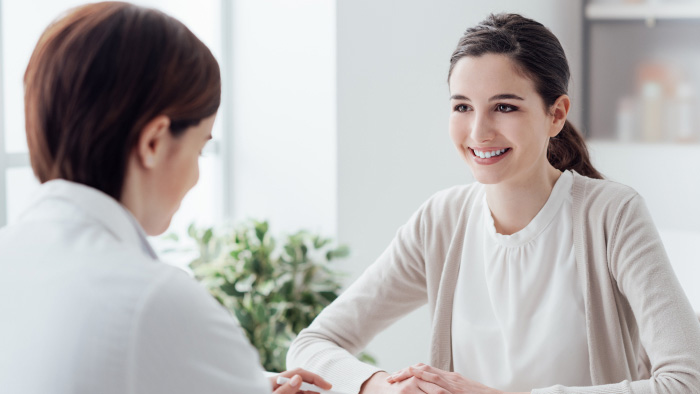 Two women facing each other having a discussion